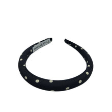 Load image into Gallery viewer, Black headband with white polka dots on a light gray background