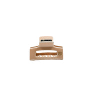 A beige claw clip hair accessory made of acetate, displayed against a white background.