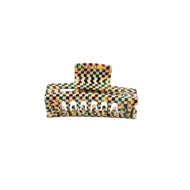 A multicolored geometric-patterned claw hair clip on a white background.