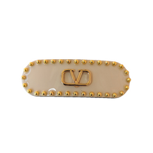 Load image into Gallery viewer, Beige barrette clip with gold studs and logo on a white background
