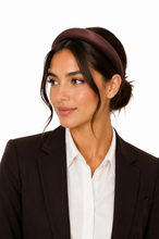 Load image into Gallery viewer, Girl in work wear wearing a brown satin padded headband against a white background with low bun.
