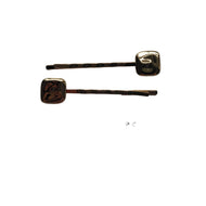 Gold hair pins on a white background