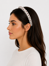 Load image into Gallery viewer, Woman wearing a white headband with red polka dots on a plain background
